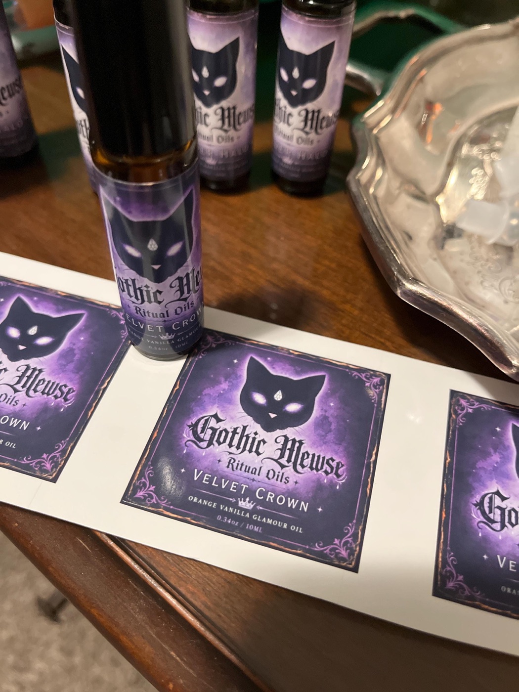 A roller bottle beside a sheet of Velvet Crown labels